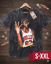 T-shirt with a graphic of a basketball player in a Bulls jersey on a wooden surface with coins.